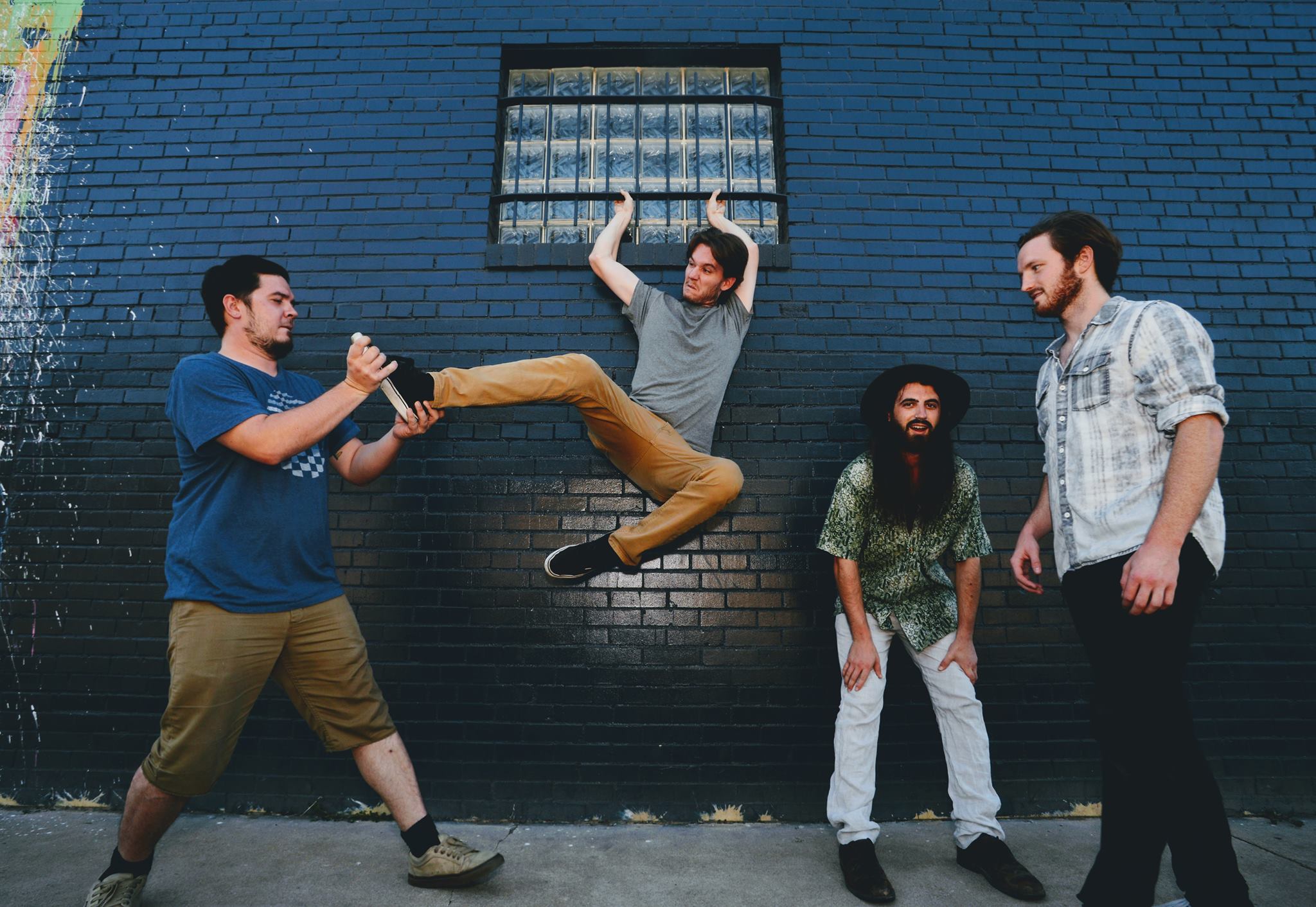 Band hanging out in front of brick wall